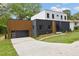 Modern two-story home featuring a black brick facade, wood paneled garage, and a well-manicured front yard at 223 Altoona Sw Pl, Atlanta, GA 30314