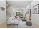 Cozy living room featuring light hardwood floors, a comfortable white sofa, and stylish decor at 223 Altoona Sw Pl, Atlanta, GA 30314