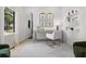 Bright home office with natural light, neutral decor, a desk, a white chair, and stylish shelving at 223 Altoona Sw Pl, Atlanta, GA 30314