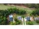 Aerial view featuring a home with a pool, landscaped yard, and golf course in the distance at 240 Huiet Dr, Mcdonough, GA 30252