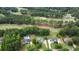 Aerial view of the property showcasing a pool, lush landscaping, and access to a nearby golf course at 240 Huiet Dr, Mcdonough, GA 30252