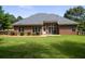 Spacious backyard with a well-maintained lawn, brick exterior, and an inviting patio area at 240 Huiet Dr, Mcdonough, GA 30252