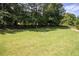 Large grassy backyard with mature trees providing shade and a peaceful atmosphere at 240 Huiet Dr, Mcdonough, GA 30252