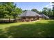Expansive backyard with lush green grass, a privacy fence, and mature trees creating a serene setting at 240 Huiet Dr, Mcdonough, GA 30252