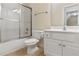 View of a bathroom with a toilet, sink, and walk-in shower behind sliding doors at 240 Huiet Dr, Mcdonough, GA 30252