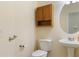 Bathroom with single sink vanity, mirror, toilet, and grab bar at 240 Huiet Dr, Mcdonough, GA 30252
