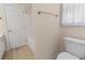 View of the bathroom with a white toilet, shower/tub with tile flooring at 240 Huiet Dr, Mcdonough, GA 30252