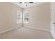 Carpeted bedroom featuring two large windows and a ceiling fan at 240 Huiet Dr, Mcdonough, GA 30252