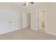 Carpeted bedroom with double closets and an open door to the Primary bathroom at 240 Huiet Dr, Mcdonough, GA 30252