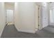 Hallway with neutral paint and carpet, connecting different rooms in the house at 240 Huiet Dr, Mcdonough, GA 30252