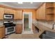Well-equipped kitchen boasts granite countertops, stainless steel appliances, and wooden cabinetry at 240 Huiet Dr, Mcdonough, GA 30252