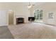 Bright living room featuring a cozy fireplace, large windows, and an open, airy layout at 240 Huiet Dr, Mcdonough, GA 30252