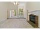 Bright living room features high ceilings, fireplace, and large windows, offering ample natural light at 240 Huiet Dr, Mcdonough, GA 30252