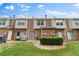 Brick townhomes with green backyard and patio area at 274 Paden Cove Trl, Lawrenceville, GA 30044