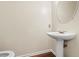 Half bath with pedestal sink and hardwood floors at 274 Paden Cove Trl, Lawrenceville, GA 30044