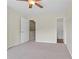 Bedroom featuring an open doorway to the bathroom and ceiling fan at 274 Paden Cove Trl, Lawrenceville, GA 30044