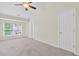Bedroom featuring large window and neutral carpet at 274 Paden Cove Trl, Lawrenceville, GA 30044
