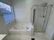 Bathroom featuring a soaking tub next to a separate glass enclosed shower at 2887 Royal Blf, Decatur, GA 30030