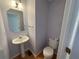 Cozy powder room featuring a pedestal sink, toilet, and a mirror at 2887 Royal Blf, Decatur, GA 30030