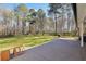Expansive backyard with a concrete patio, lush green grass, and mature trees at 950 Besse Way, Locust Grove, GA 30248