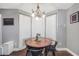 Inviting breakfast nook featuring a round table, modern light fixture, and lots of natural light at 950 Besse Way, Locust Grove, GA 30248