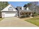 Charming two-story home with a two-car garage, brick accents, and a well-manicured lawn at 950 Besse Way, Locust Grove, GA 30248