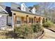 Charming brick home with wood-stained columns, shuttered windows, and manicured landscaping at 950 Besse Way, Locust Grove, GA 30248