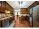Charming kitchen with stainless steel appliances, wooden cabinets, and seamlessly connected to dining area at 950 Besse Way, Locust Grove, GA 30248