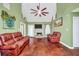Inviting living room features a cozy fireplace, plush seating, and a large window for natural light at 950 Besse Way, Locust Grove, GA 30248