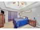 Inviting bedroom featuring tray ceiling, wood-look floors, ceiling fan and two dressers at 950 Besse Way, Locust Grove, GA 30248