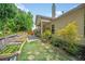 Landscaped backyard featuring a patio, planters, and well-maintained lawn at 1867 Willoughby Dr, Buford, GA 30519