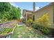Enjoy outdoor living on this covered patio with garden boxes and a tranquil backyard at 1867 Willoughby Dr, Buford, GA 30519