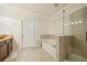 Elegant bathroom with double vanity, soaking tub, glass shower, and tile flooring at 1867 Willoughby Dr, Buford, GA 30519