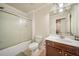 Bathroom features a shower/tub with sliding doors and a vanity with storage at 1867 Willoughby Dr, Buford, GA 30519