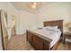 Bedroom featuring vaulted ceilings, a wood bed frame and wood floors at 1867 Willoughby Dr, Buford, GA 30519