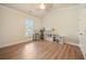 Versatile bedroom space with vaulted ceiling, wood floors, and ample natural light, perfect for an office or den at 1867 Willoughby Dr, Buford, GA 30519
