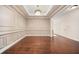 Elegant dining room featuring hardwood floors, wainscoting, and a modern chandelier at 1867 Willoughby Dr, Buford, GA 30519