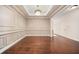 Formal dining room featuring hardwood floors, elegant wall trim and decorative lighting at 1867 Willoughby Dr, Buford, GA 30519
