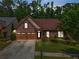 Charming brick home with well-manicured landscaping and a two-car garage at 1867 Willoughby Dr, Buford, GA 30519