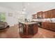 Bright kitchen with a large island, granite countertops, and access to the living area at 1867 Willoughby Dr, Buford, GA 30519