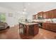 Lovely eat-in kitchen with granite counters, stainless steel appliances, central island, and hardwood floors at 1867 Willoughby Dr, Buford, GA 30519