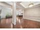 Open-concept living room showcasing hardwood floors, elegant trim, and seamless flow to kitchen at 1867 Willoughby Dr, Buford, GA 30519