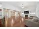 Open living area showcasing hardwood floors, a fireplace, and views of the kitchen and staircase at 1867 Willoughby Dr, Buford, GA 30519
