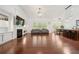 Open living room design with hardwood floors, a fireplace, and access to dining and kitchen spaces at 1867 Willoughby Dr, Buford, GA 30519