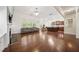 Living room with hardwood floors, fireplace, built-ins, and view into the kitchen at 1867 Willoughby Dr, Buford, GA 30519