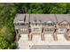 Aerial shot of brick townhomes nestled among lush trees, showcasing their harmonious integration with the surrounding landscape at 2122 Pembroke Dr, Brookhaven, GA 30319
