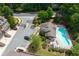 Aerial view of community pool, pool house, landscaped grounds and parking at 2122 Pembroke Dr, Brookhaven, GA 30319