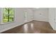Bright bedroom features hardwood floors, neutral walls, two windows and a door to balcony at 2122 Pembroke Dr, Brookhaven, GA 30319