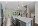 Bright, open kitchen boasts an island with a farmhouse sink and views of the living area at 2122 Pembroke Dr, Brookhaven, GA 30319