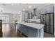Stylish kitchen with a spacious island, stainless appliances, and contemporary lighting at 2122 Pembroke Dr, Brookhaven, GA 30319